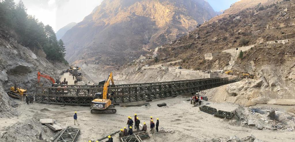 The work of rebuilding the bridge that was swept away by the Rishiganga disaster near Raini village on the Joshimath-Malari highway